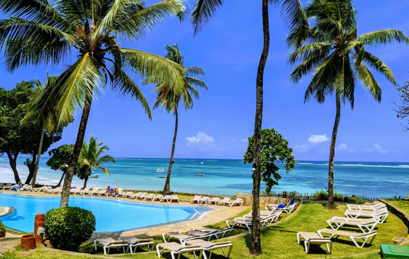 Mombasa Kenya beach resort with swimming pool, palm trees, sun loungers, and ocean view
