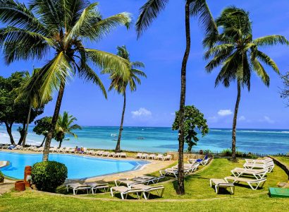 Mombasa Kenya beach resort with swimming pool, palm trees, sun loungers, and ocean view